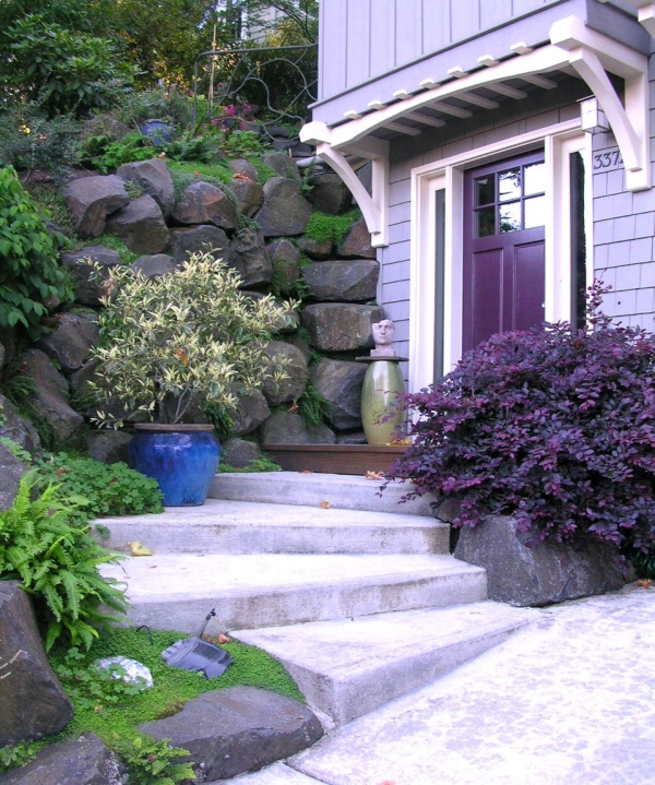 examples of garden design stairs shrub purple stone wall
