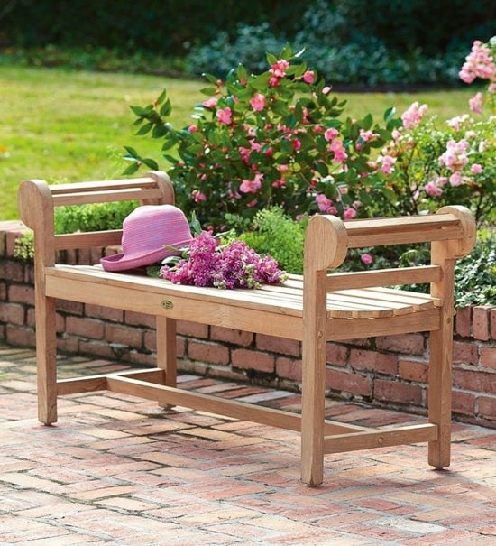 simple garden bench stone wall rose pink color