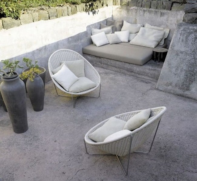 small terrace exposed concrete floor cushion chair pottery