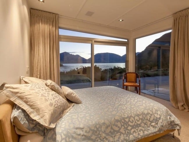 bedroom corner window house with lake in New Zealand
