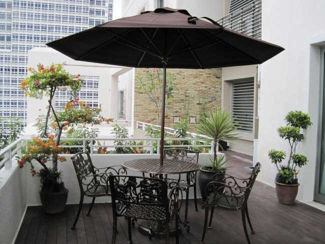 urban rooftop palm flower pots iron furniture Parasol