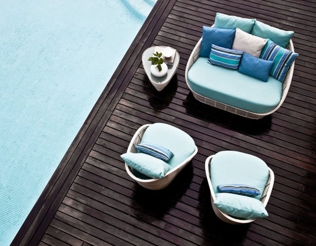 wooden deck pool area rattan garden furniture by Kenneth Cobonpue