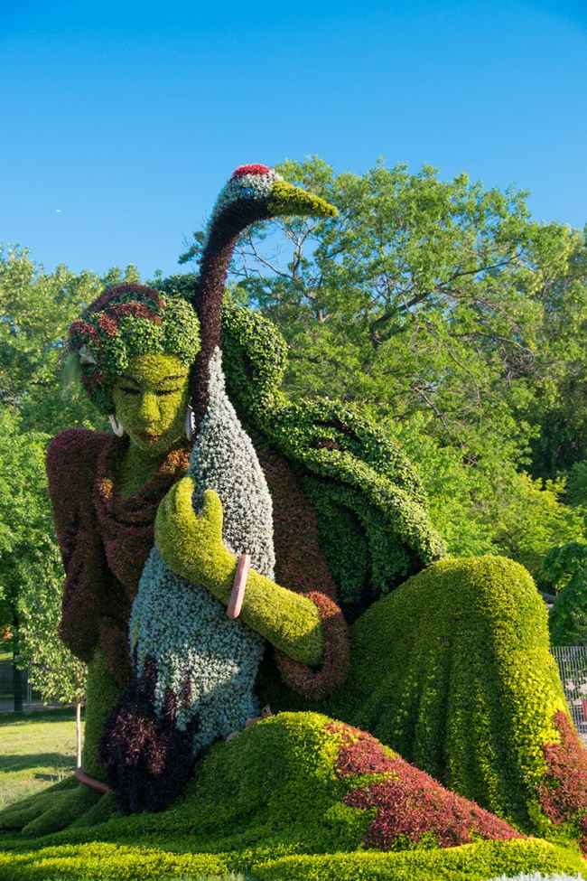 Frau mit Vogel Skulptur-Pflanzen-Blumen Guy Boily