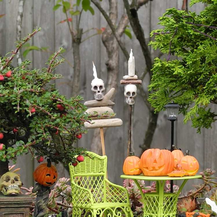 halloween gartendeko ideen totenkopf kerzenstaender kuerbisse stuhl gruen