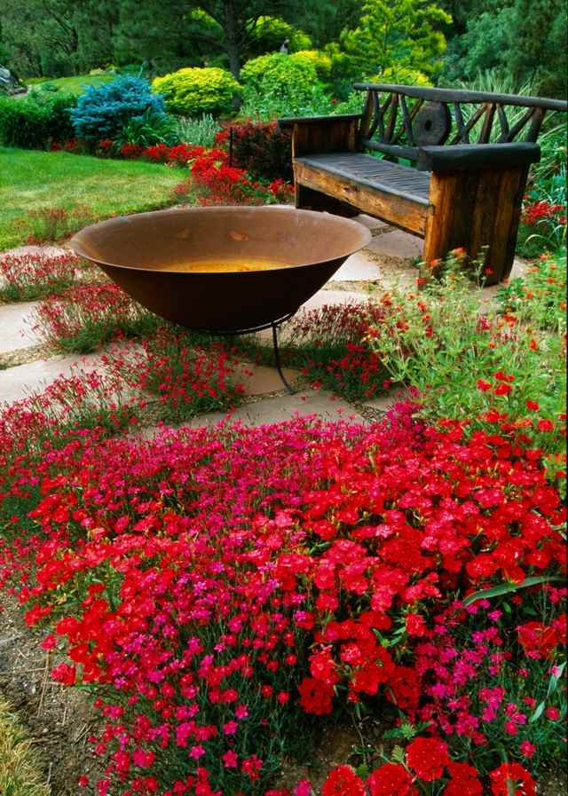 Blumen Gartenbank rote Blumen Holz Feuerstelle
