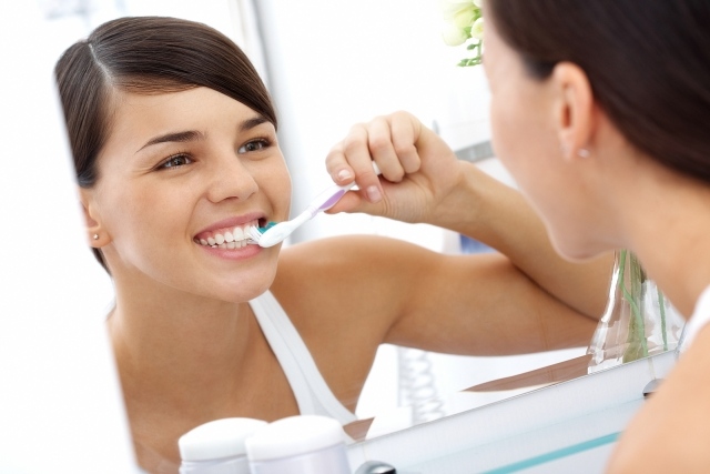 frau zähne putzen gute mundhygiene wichtig regelmäßig besuchen