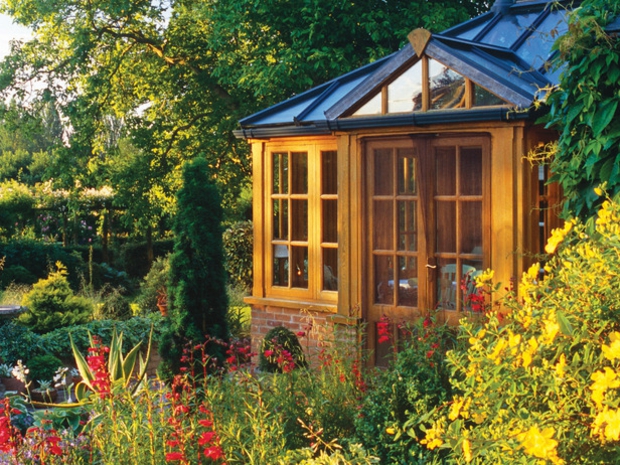 Gartenhaus Pflanzen Stein Holz Glas schöne Gartengestaltung Ideen