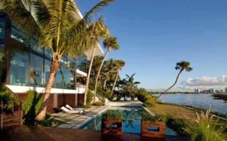 Karibien Ferienvilla hohe Palmen Pool Holzterrasse schöner Blick Glasfronten