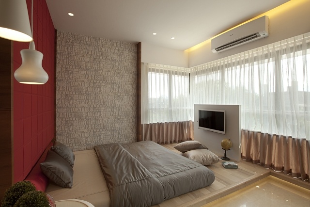 schlafzimmer-design-taupe-rote-akzentwand-tv-halterung