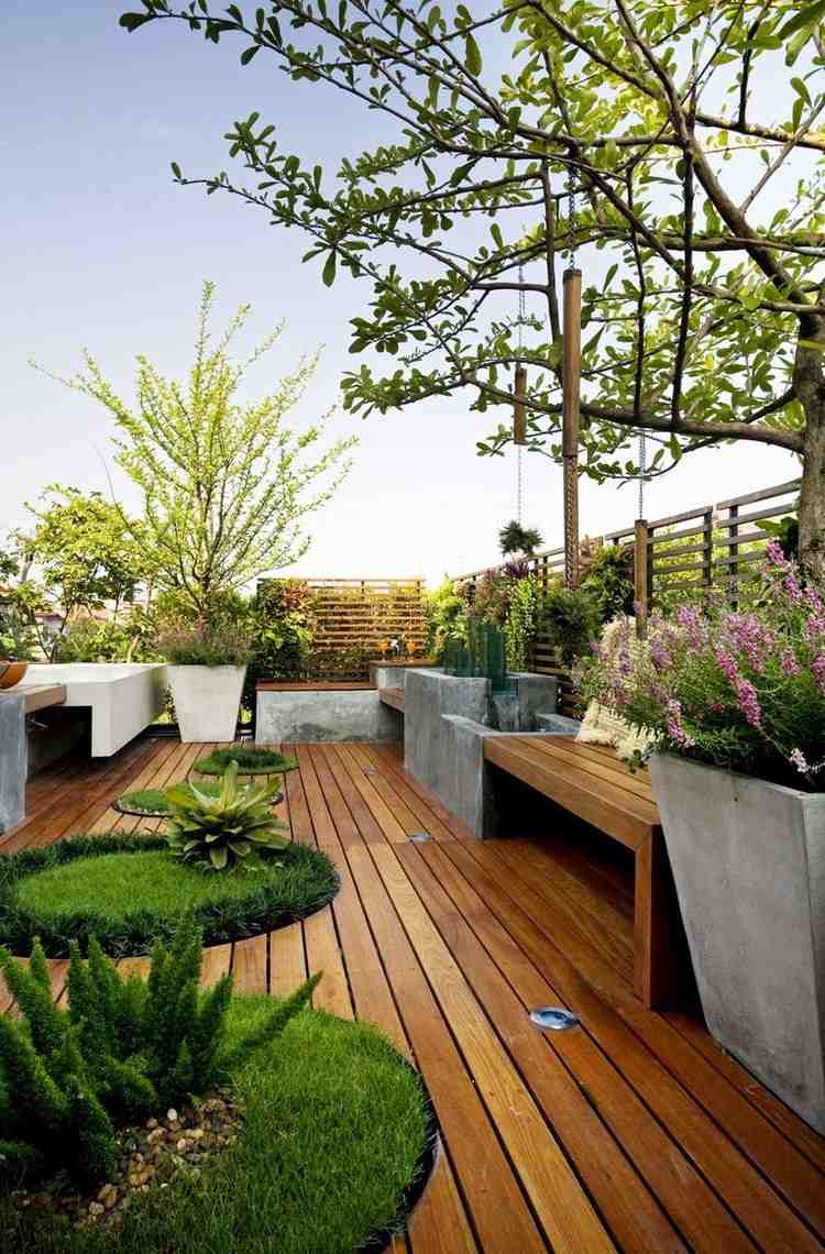 moderne-terrassen-ideen-runde-ausschnitte-gras-terrassendielen-holz-beton-pflanzkuebel