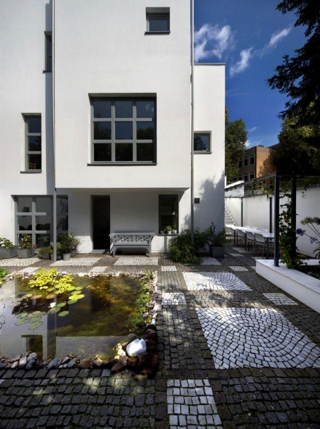 Garten-als-Essplatz-weiß-verputzte-hausfassade-klare-geometrie-aus-kuben-renovierung