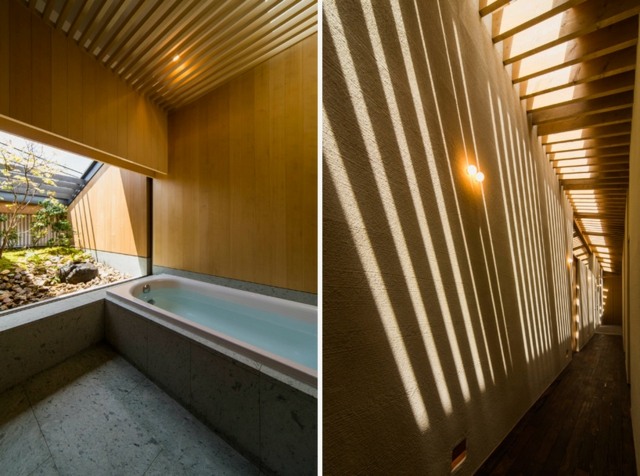 Badezimmer freistehende Badewanne Naturstein Fliesen Dachfenster Holzbalken