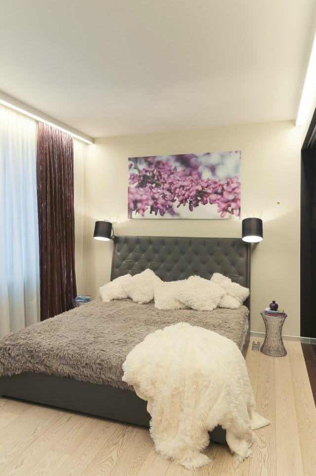 schlafzimmer-dekorieren--ecru-wandfarbe-poster-lila-bluetenzweig-graues-polsterbett