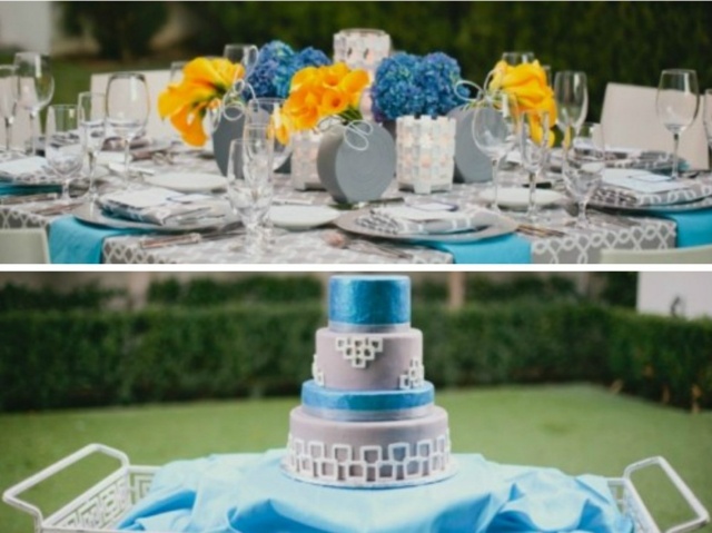 Hochzeitstorte-mit-blauen-Akzenten-Blumen-auf-dem-Tsch-in-Orange