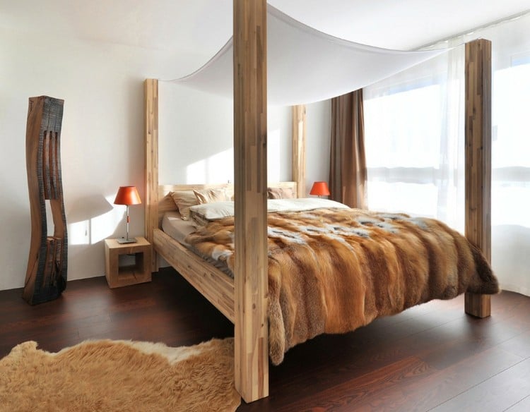 alpen stil holz balken schlafzimmer bett fell tagesdecke