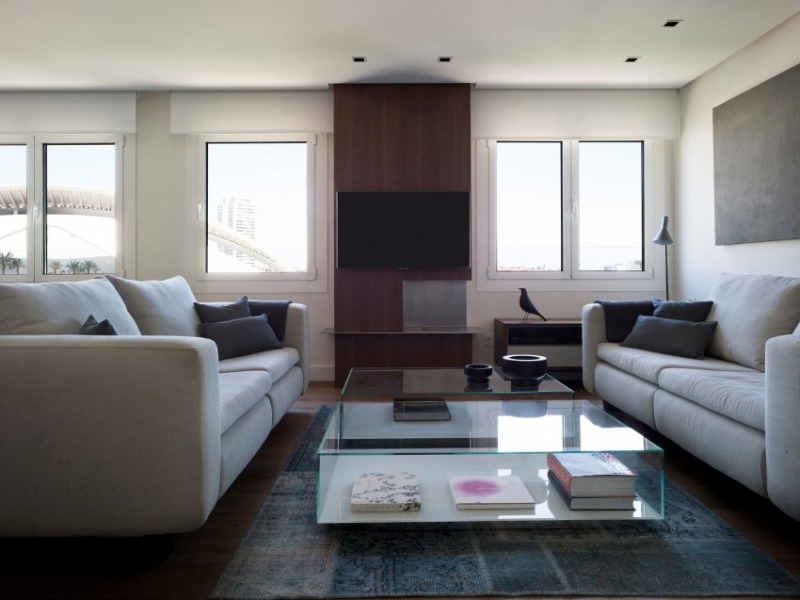 einrichtung-wohnzimmer-couches-gegenueber-couchtisch-glas-teppich-vintage-fenster-tvwand