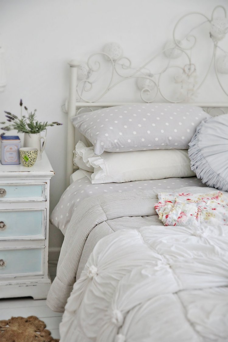 weiße-schlafzimmermoebel-stil-gestaltung-traditionell-metallbett-alt-kissen-nachttisch