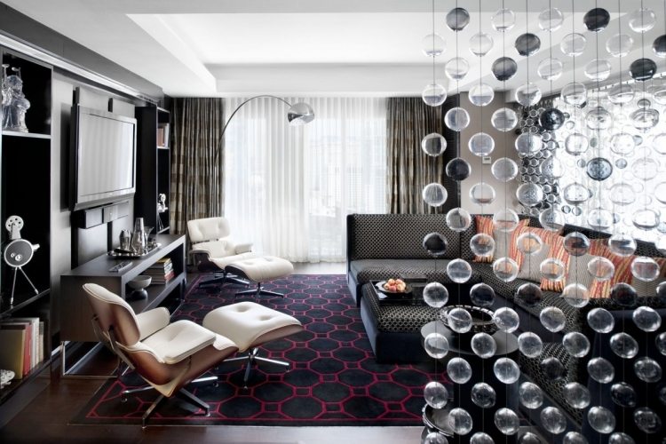 Wohnzimmer in Grau -eckcouch-teppich-sessel-eames-wohnwand-lampe-arco-glasperlen-raumteiler