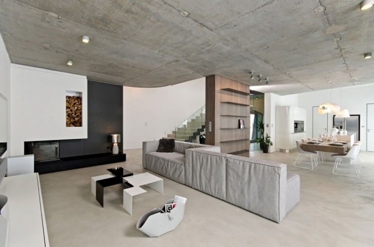 beton-design-modern-offene-raeume-esstisch-integrierter-kamin-modulare-couch-couchtisch-zeitgenossisch
