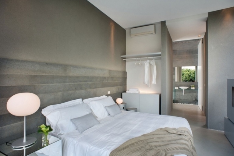 beton-design-modern-schlafzimmer-bett-bettwaesche-offen-bad-indirekte-beleuchtung-bettwaesche