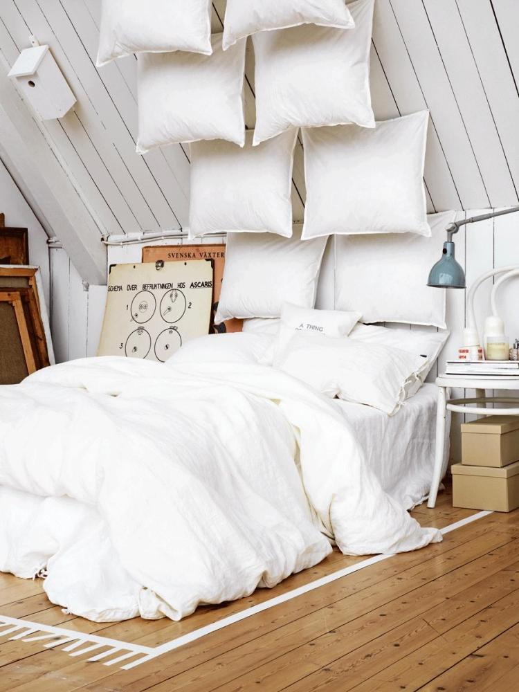 bohemian-style-schlafzimmer-weiss-kreative-idee-kissen-decke-dielenboden-teppich-klebeband