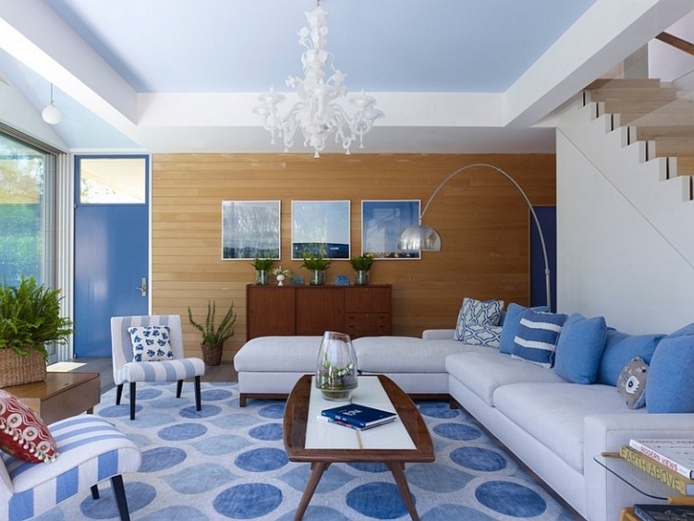 wohnen-blau-weiss-modern-wohnzimmer-teppich-muster-kreise-eckcouch-krobleuchter-polstermoebel-holzwand