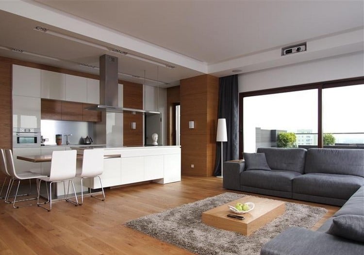 modernes-wohnzimmer-sofa-grau-holzboden-weisse-wohnkueche