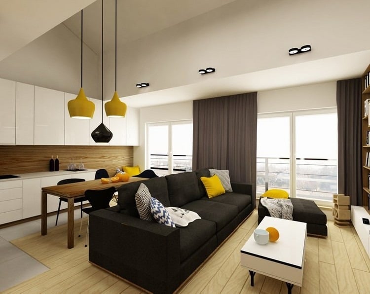 modernes-wohnzimmer-sofa-schwarz-heller-holzboden-weisse-wohnkueche-gelbe-akzente
