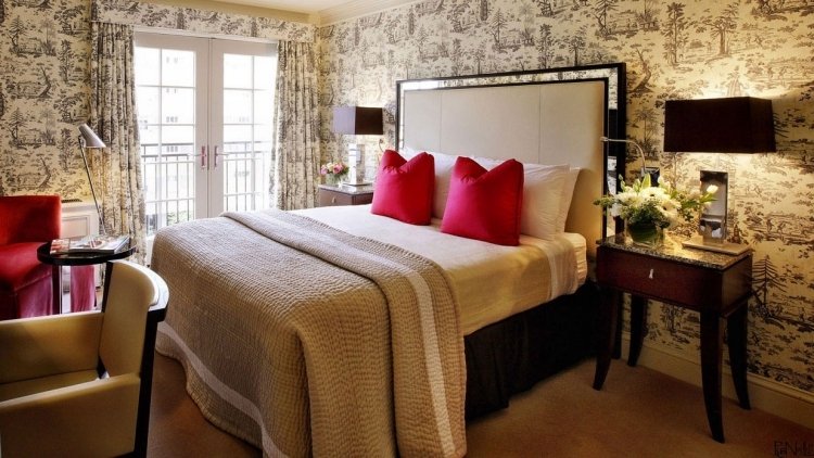 vintage-tapeten-modern-interieur-schlafzimmer-gelblich-weiss-schwarz-kissen-pink-samt