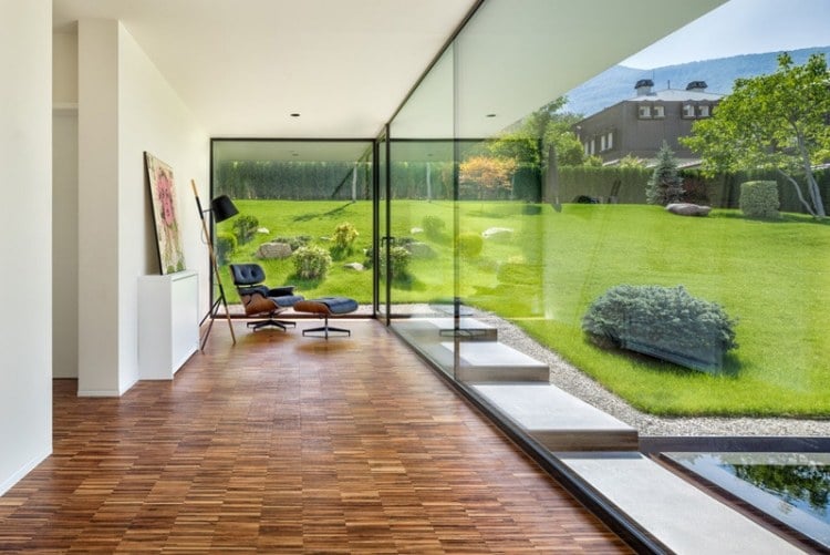 glas-waende-innen-aussen-licht-bambusboden-panorama-garten-sessel-ausblick