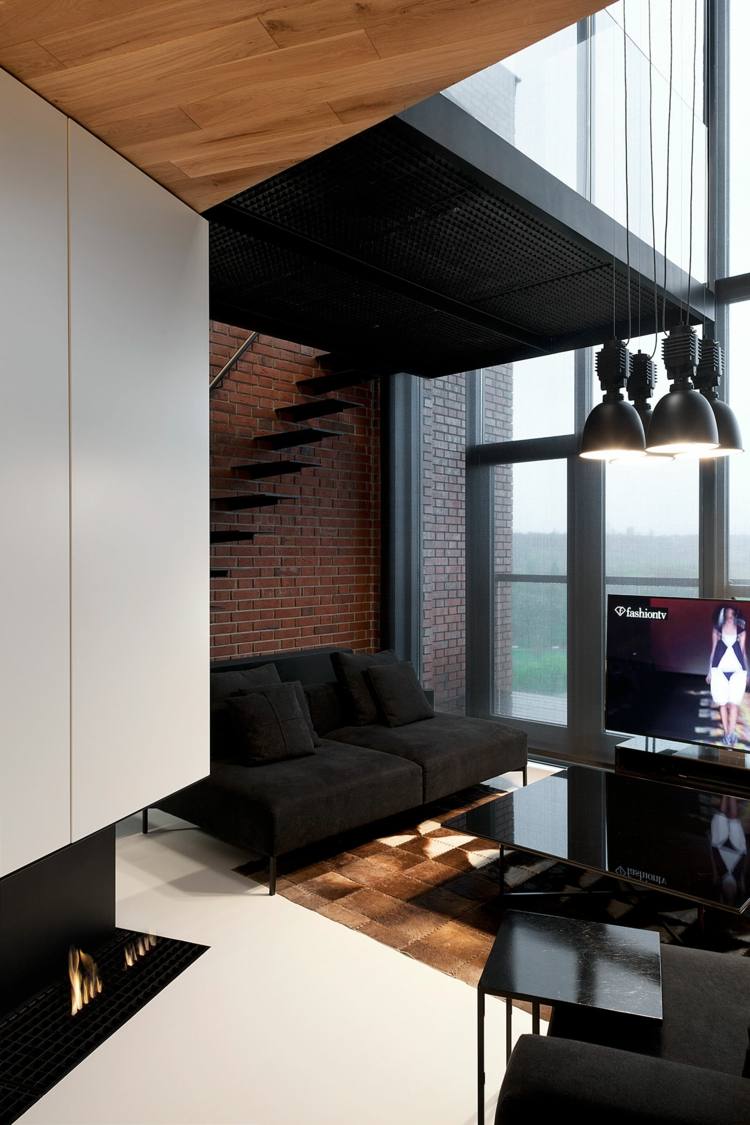 wohnzimmer-ideen-schwarzes-sofa-luxus-modern-backsteinwand-offen-kamin-hochglanz