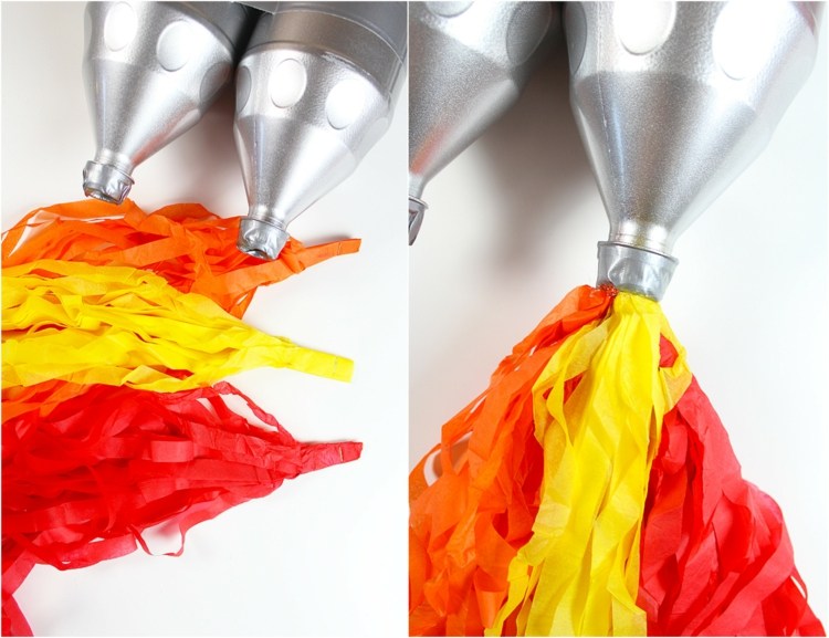 fasching-basteln-kinder-plastikflaschen-leer-bemalt-silber-papier-streifen-bündel-gelb-orange-raketen