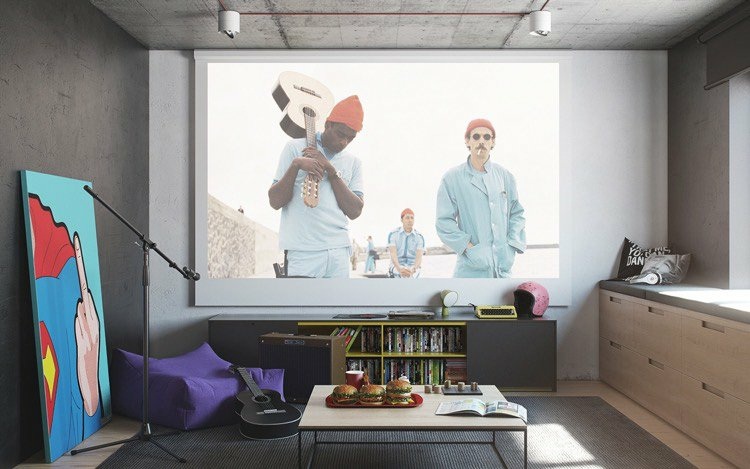 beamer-wohnzimmer-integrieren-betonwand-deckenleuchten-tisch-sitzkissen-tisch-gitarre-burger-teppich