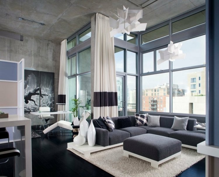 betonwand-selber-machen-wohnbereich-fensterfront-eckcouch-teppich-bar-barstühle-relaxsessel-hängelampen-betonpaneele