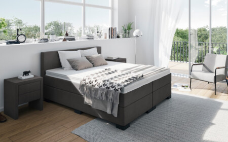 Boxspringbett-Anthrazit-gepolstert-schlafzimmer-weisse-wände-parkettboden