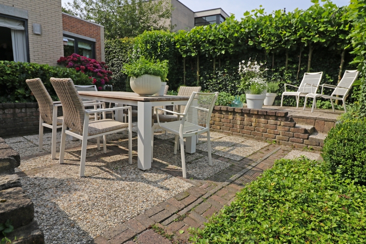 Terrasse gestalten Bodenbelag Pflastersteine moderne Gartenmöbel Sichtschutzhecke