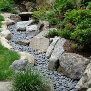 trockener bachlauf anlegen Garten Flusssteine