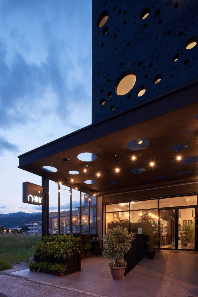 schwarze fassade modern gestalten onyx lit haus taiwan minimalistisch runde löcher design kreise inspiriert von gischt architektur projekt haupteingang