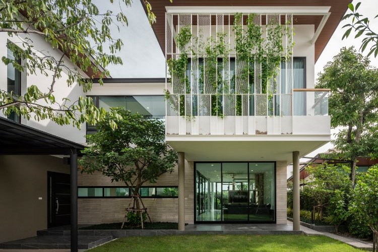 begrünte fassade designer haus moderne architektur glas terrasse natürliche umgebung bäume rasen wachsblume