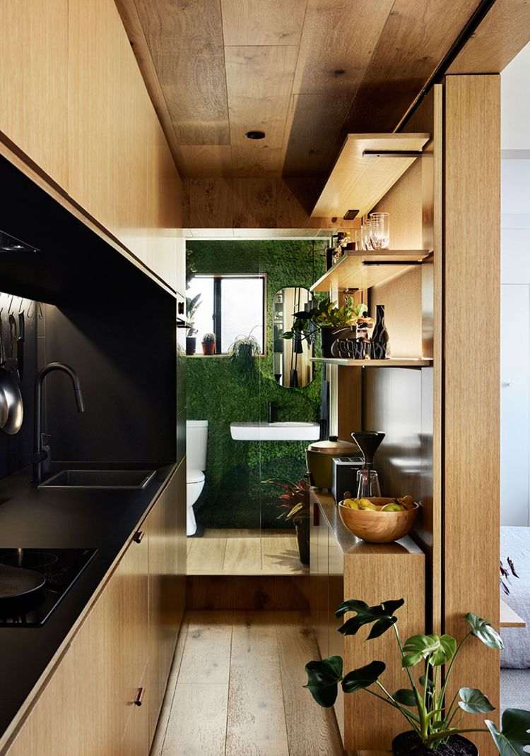 mikro wohnung einrichten minimalistisch design 70er jahre stil holzverkleidung küche badezimmer moos grün pflanzenwand lebendig