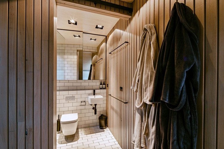 design ferienhaus schrägdach küstenwald moderne berghütte toilette spiegel waschbecken klein bademantel