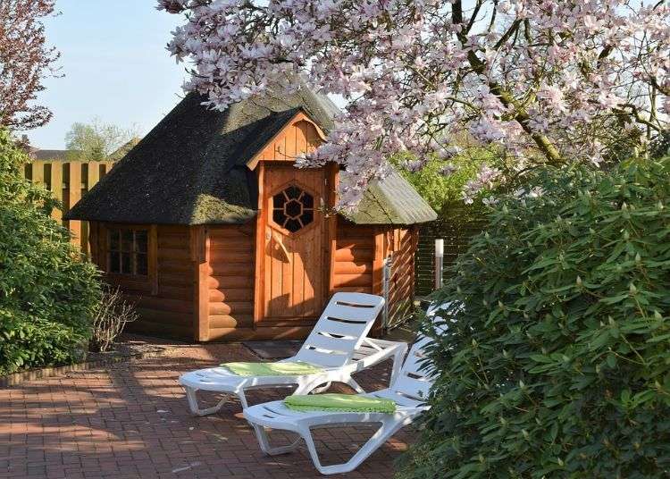outdoor sauna bauen ideen designs entspannungsbereich im freien liegestühle baum blüten holz saunahäuschen kabine