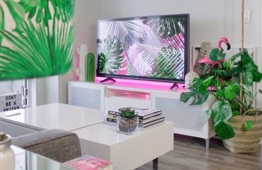 LED Streifen pink hinter Fernseher im Wohnzimmer am Sideboard geklebt