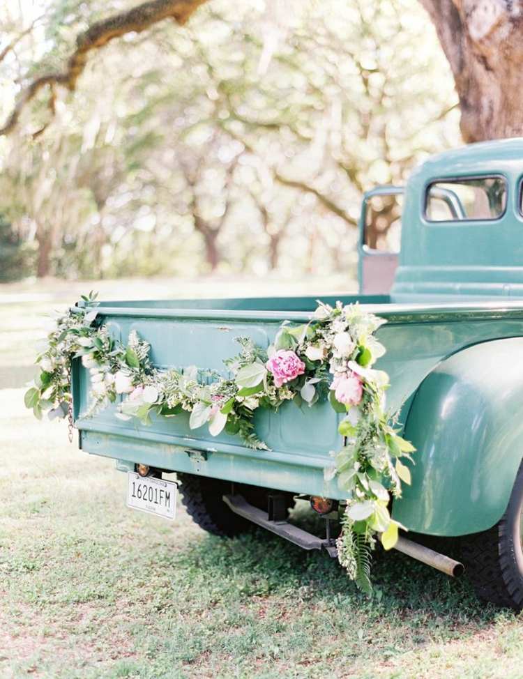 mit einer Blumengirlande zur Hochzeit das Auto dekorieren