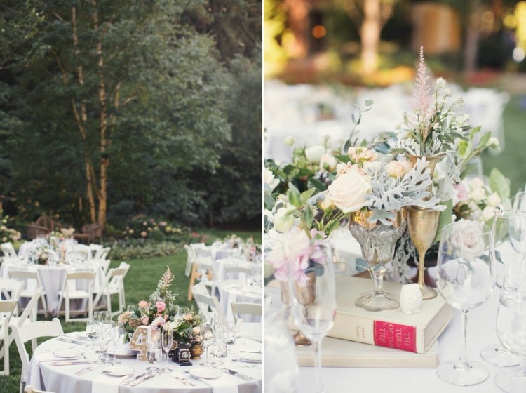runde Tische auf der Hochzeitsfeier mit Büchern als Deko und Blumen Arrangements