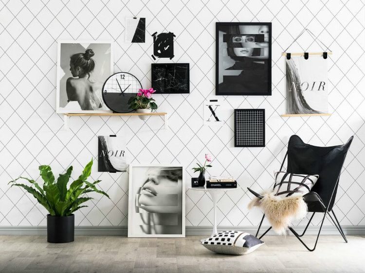 Bilderwand gestalten schwarz weiße Fotos Regale aufhängen Boden Sessel skandinavisch