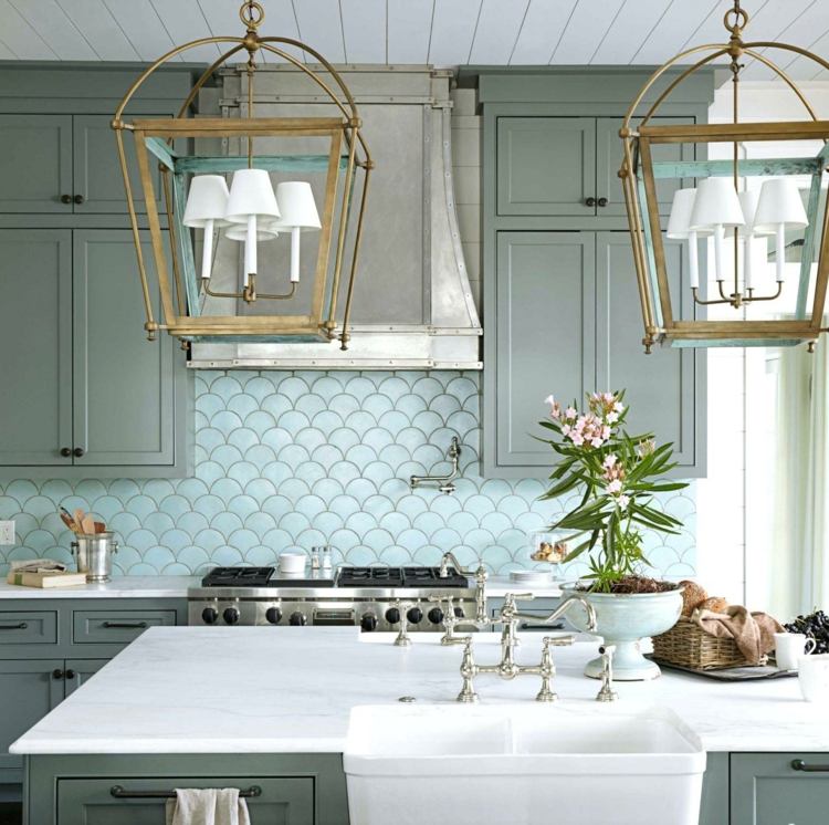 Küchenrückwand in dezentem Hellblau in einer grau-grünen Küche mit Kücheninsel
