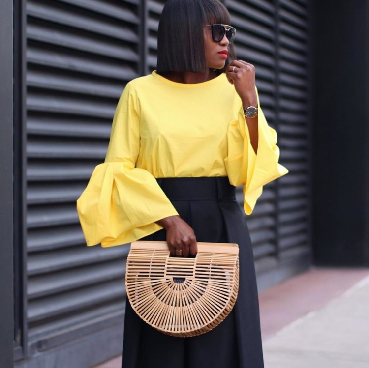 Handtaschen aus Holz gelbe Bluse Volantärmel schwarzer Rock elegant