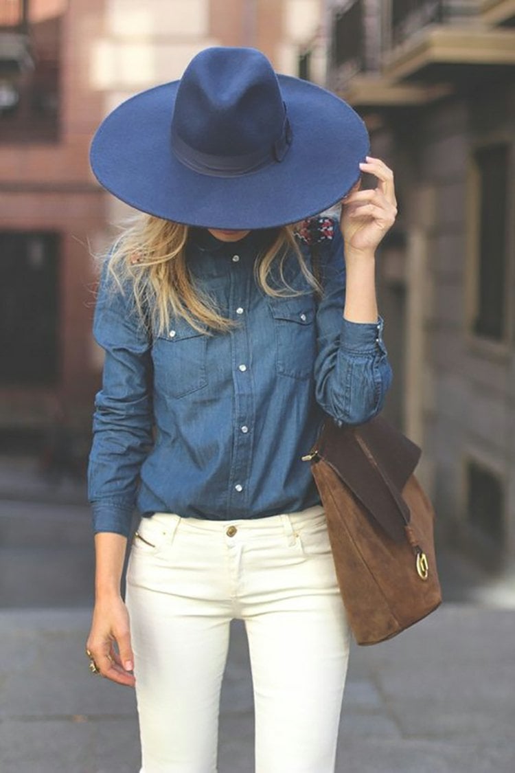 dunkelblaues Jeanshemd kombinieren weiße Jeans braune Handtasche blauer Hut Damen