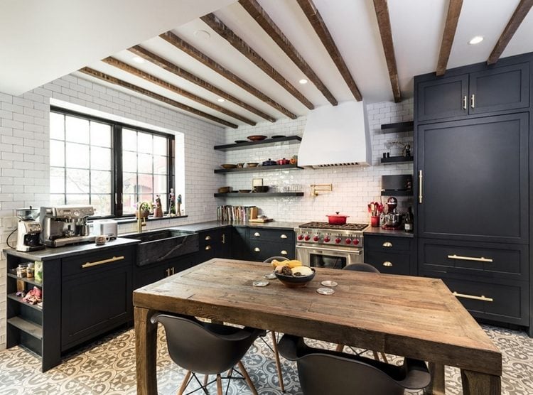 schwarze küchenmöbel in kombination mit rustikalem holztisch und designer stühlen